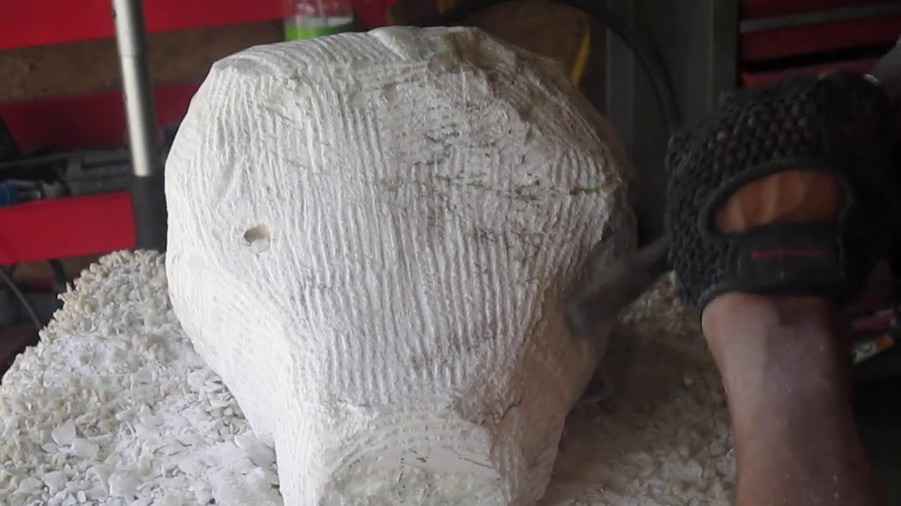 sculpting marble with a pneumatic hammer.
