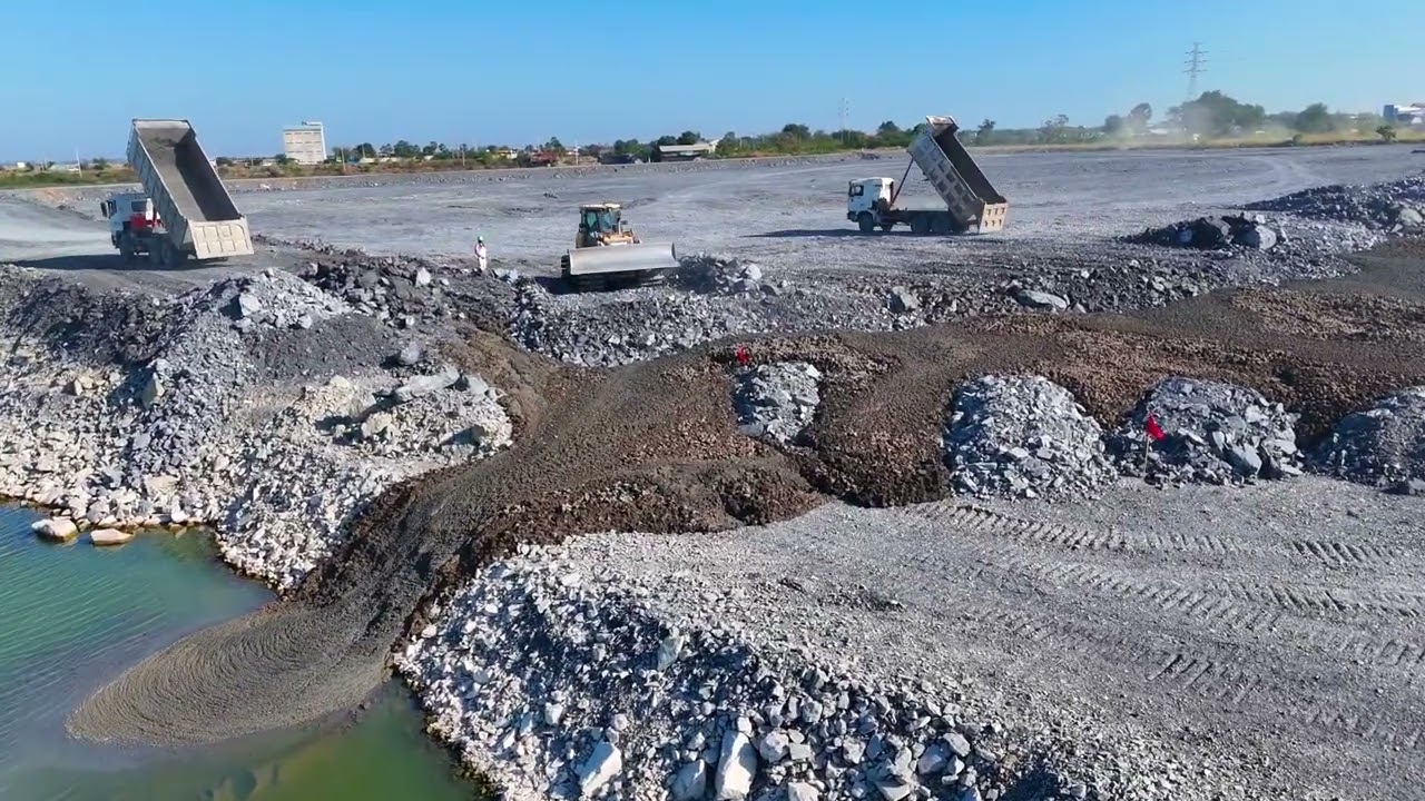 The activity of pouring the road around the lake when the construction is 100% complete