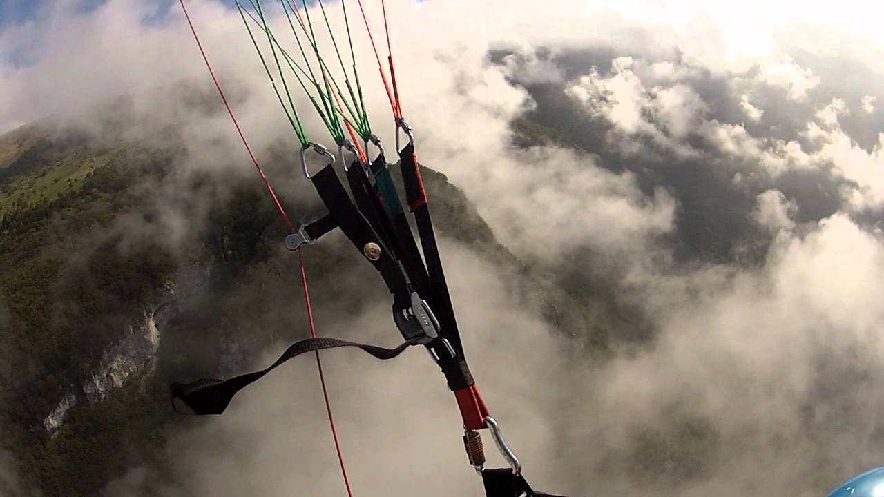 Tandem paragliding through the clouds over Malcesine - Lake Garda
