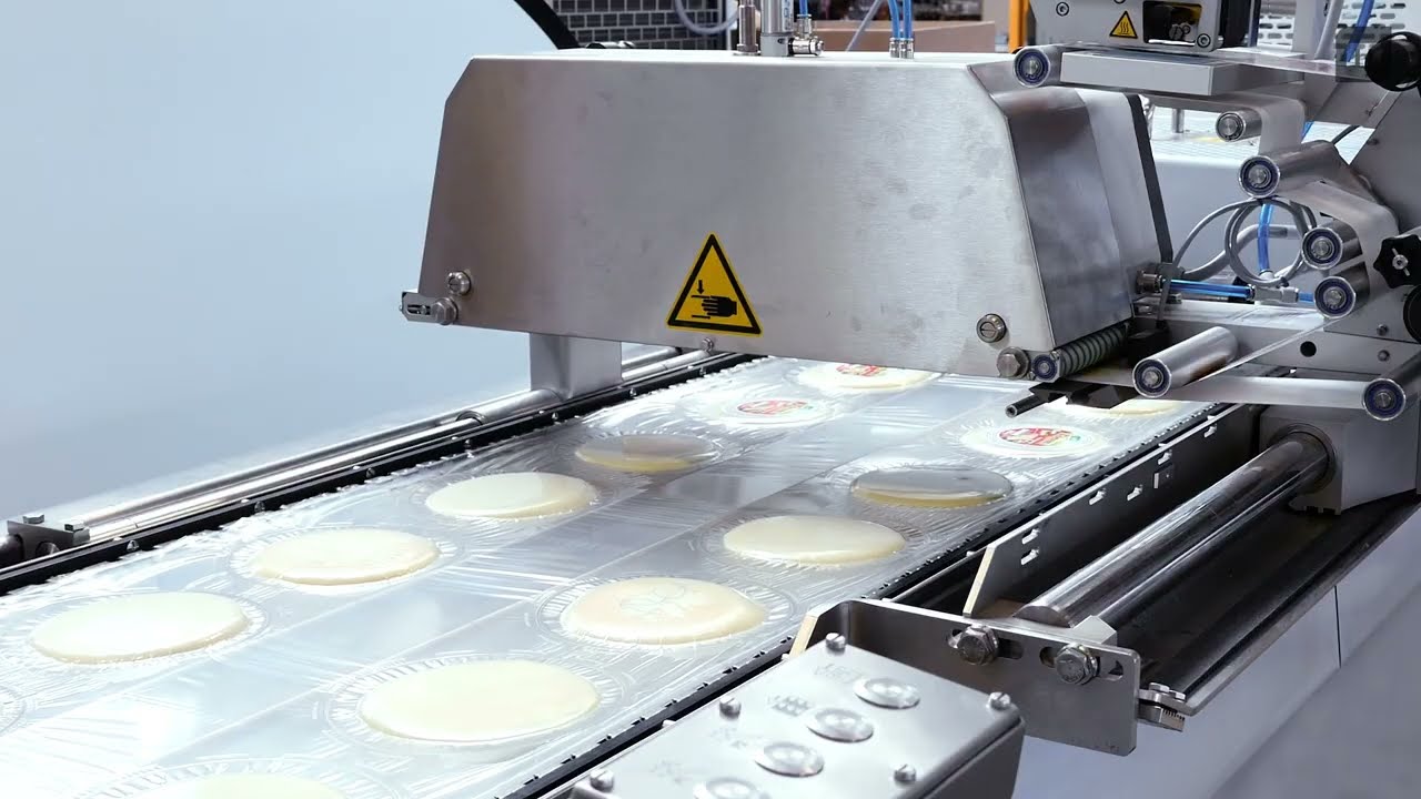 MULTIVAC Automated Thermoforming Packaging of Cheese Wheel - Customer Video - Hochwald