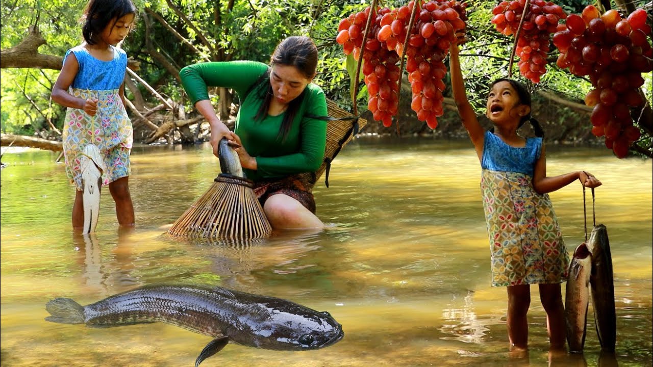 Mother with daughter fishing for food and pick grapes at river-Grilled fish with salt for lunch