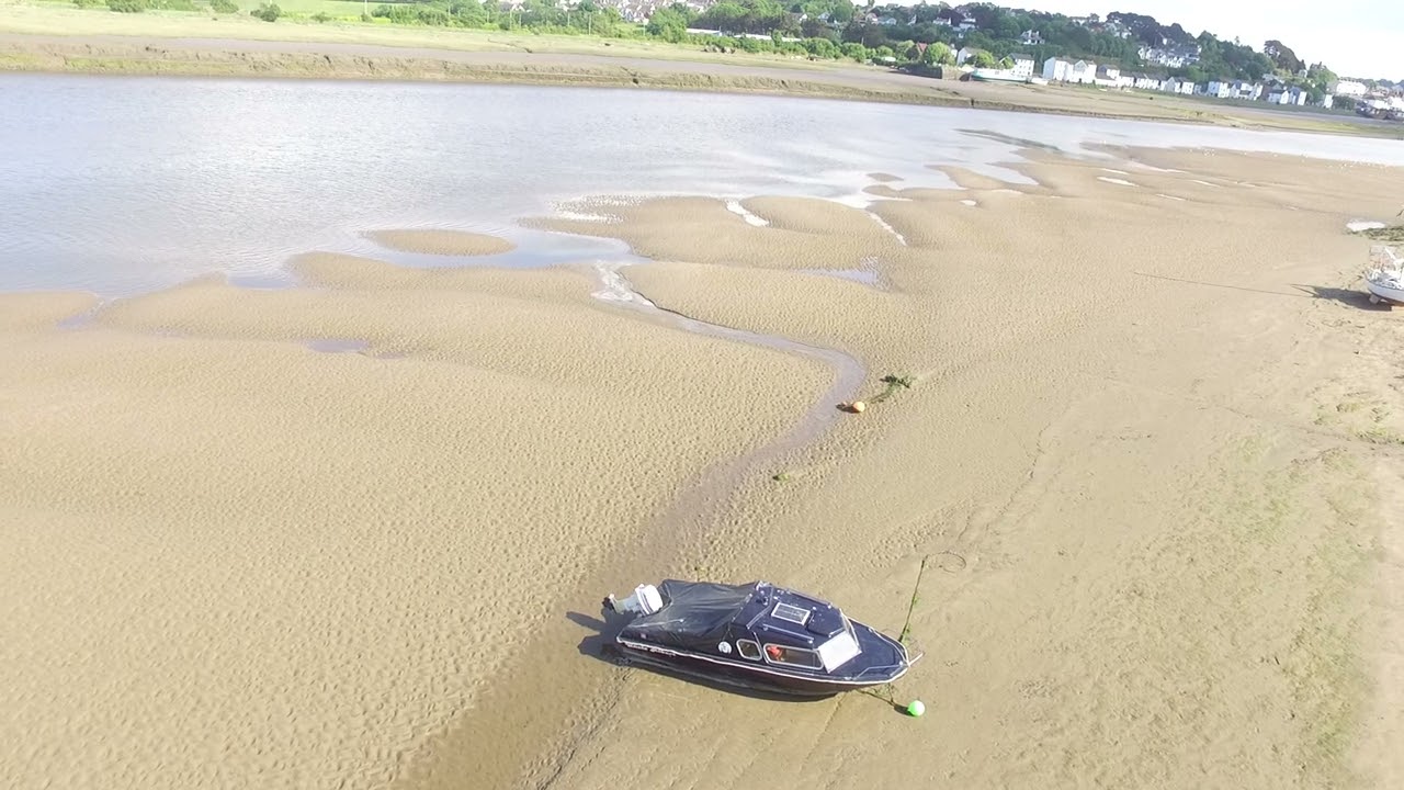 The River Torridge at Lowish Tide, Bideford, North Devon. Albert the Black Speedboat.