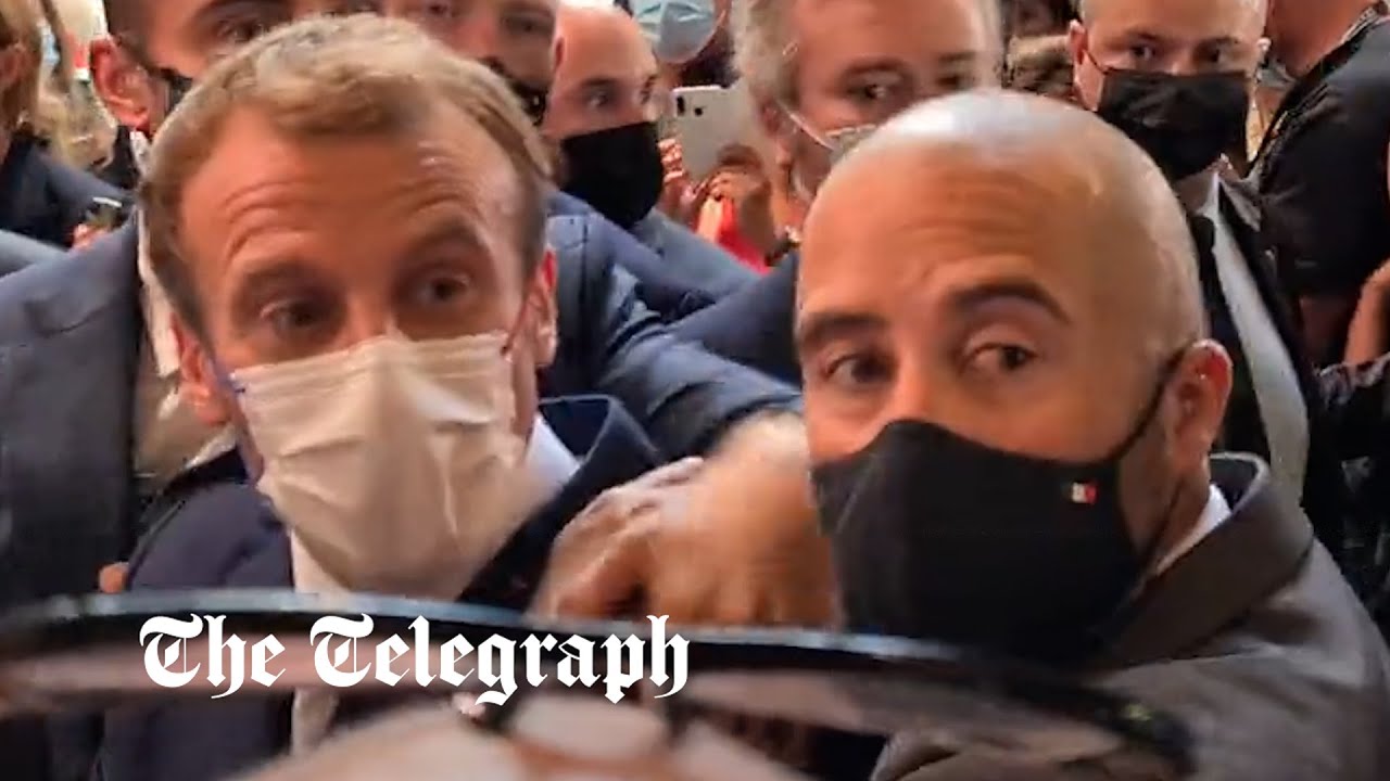 Emmanuel Macron pelted with egg by protester during restaurant fair visit in Lyon