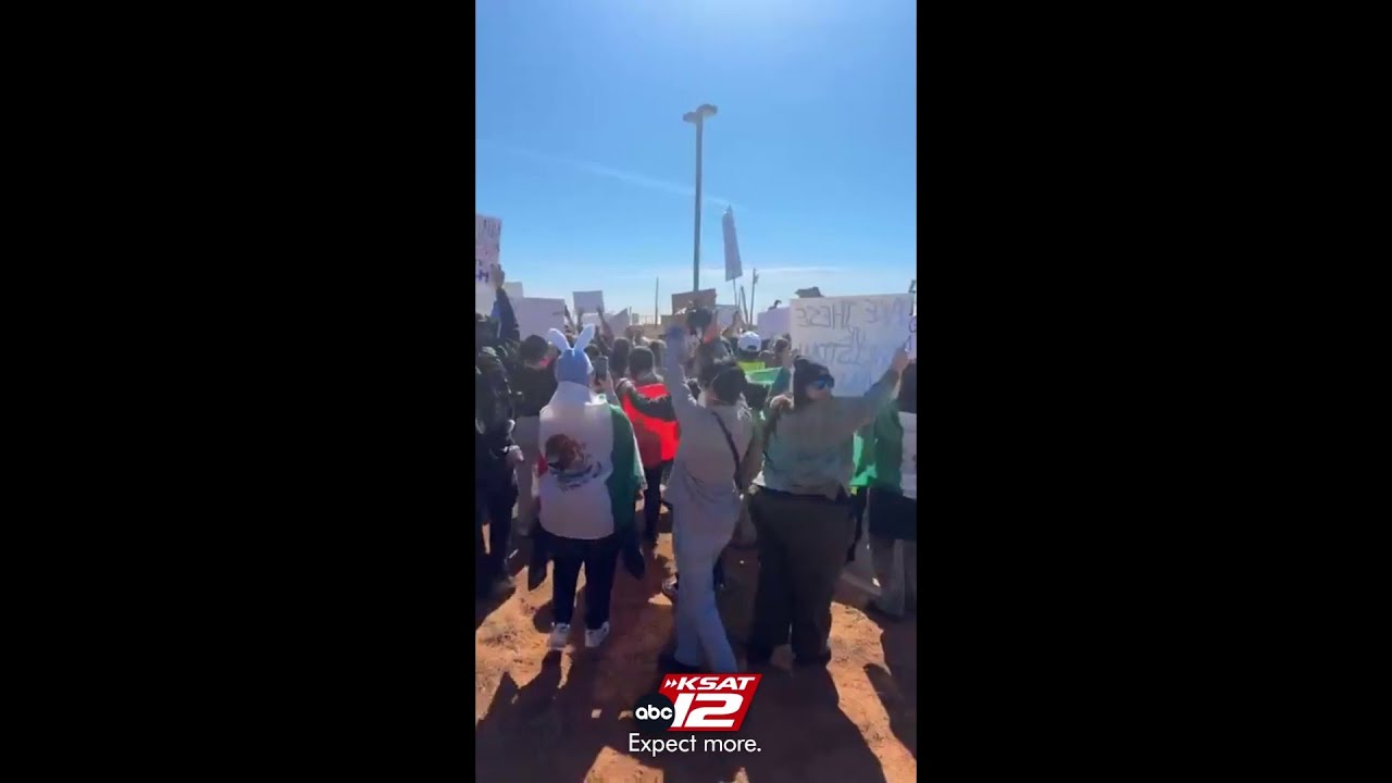 KSAT's Erica Hernandez captures crowd of protesters as they headed toward Dilley detention facility