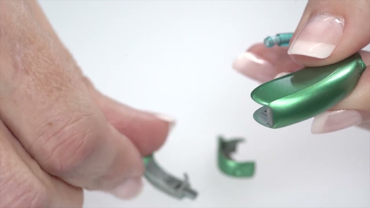 How do you tamper-proof the battery door of a hearing aid?