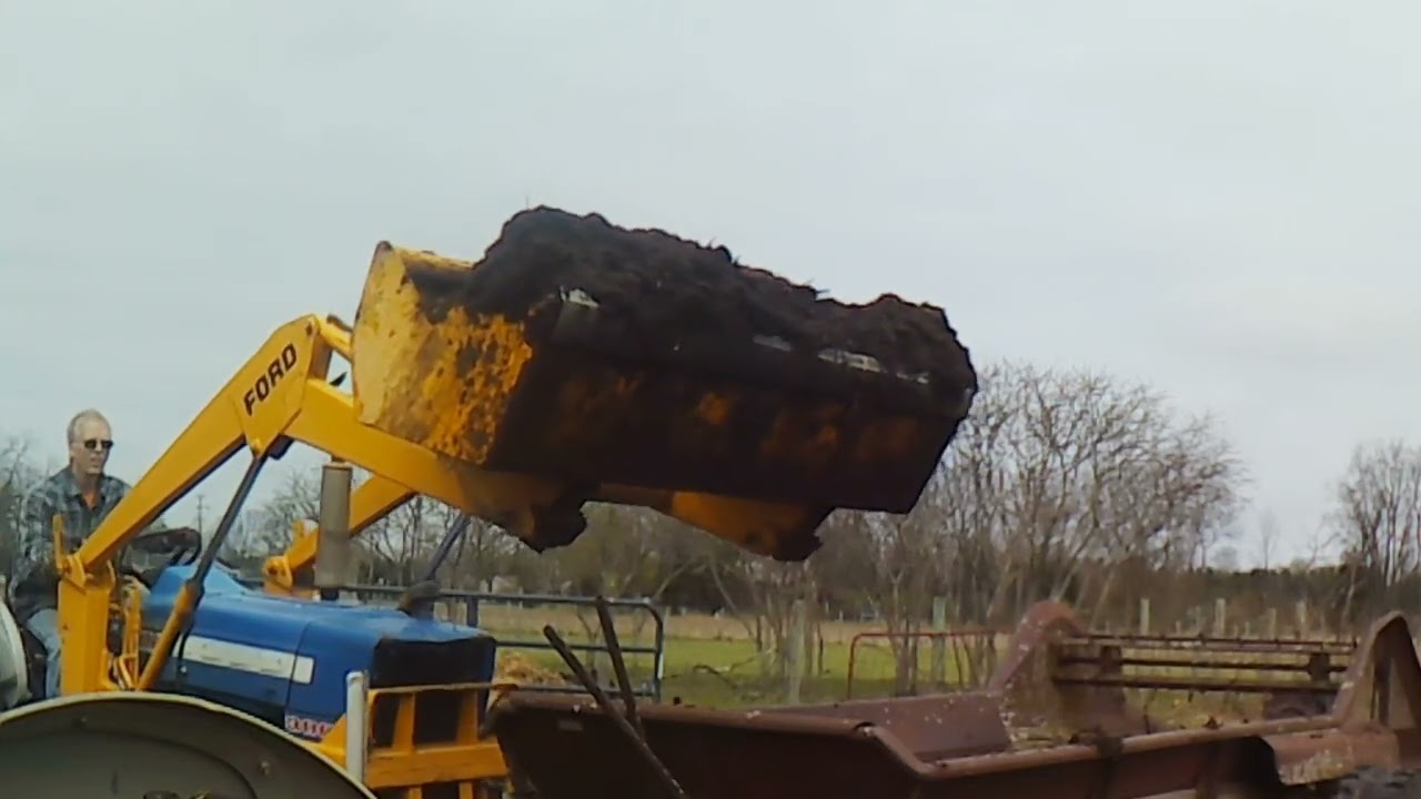 Putting manure on the hayfield