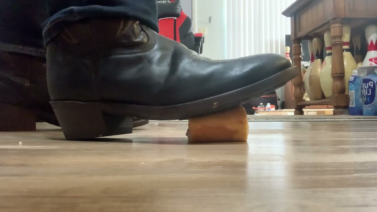 Cowboy boots crushing a shortcake roll