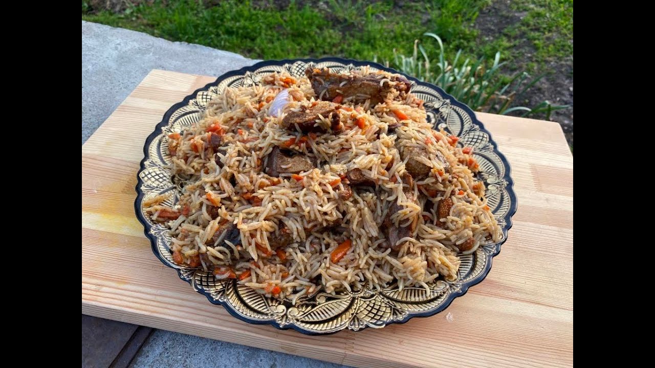 Duck pilaf in a cauldron on a fire.