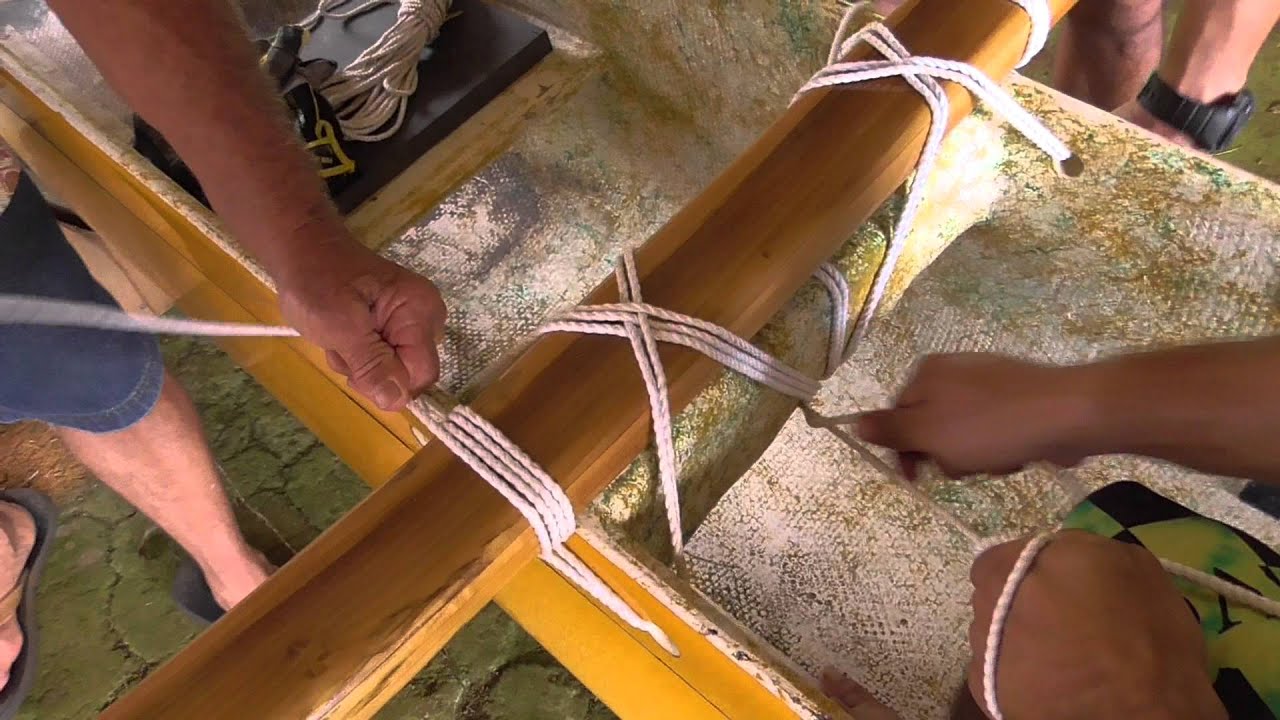 Strapping Iako to Canoe with Rope 1