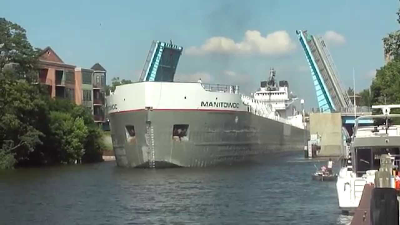 Manitowoc Great Lakes Freighter Navigates Narrow Channel In Manistee Michigan