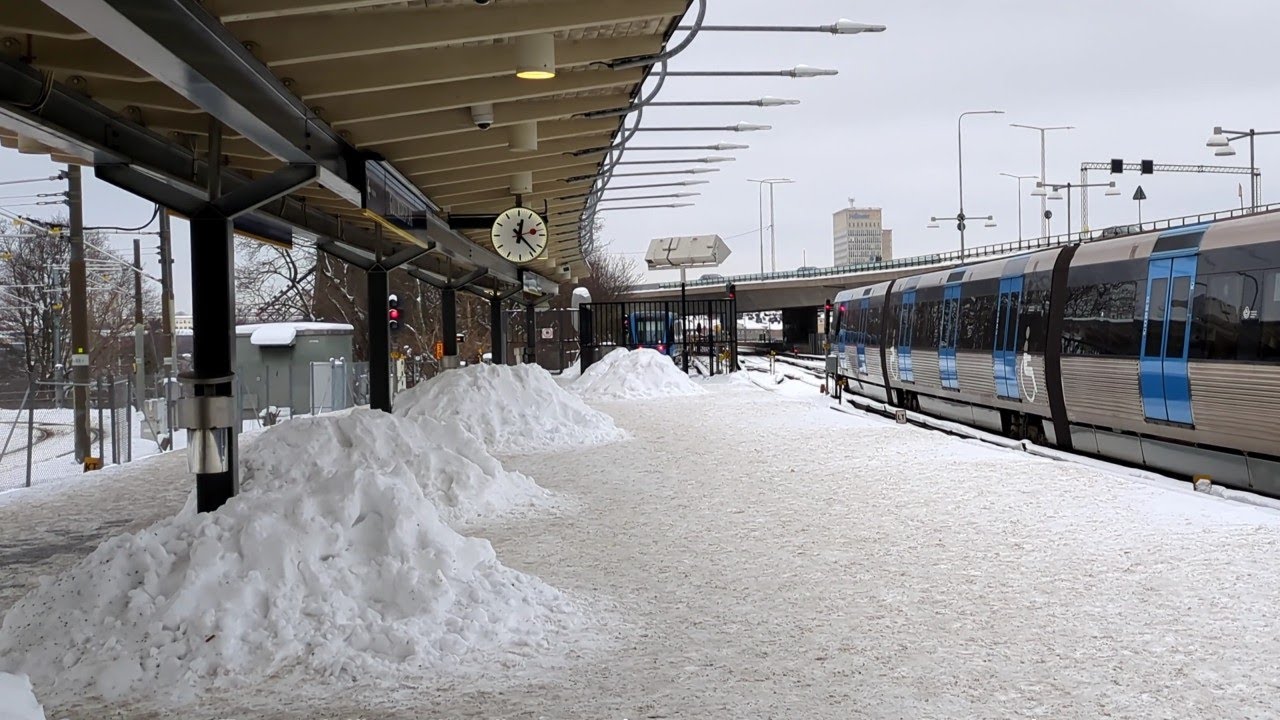 Gullmarsplan, piles of snow, Green line Stockholm metro, Tvärbanan tram. Junction. English subtitles