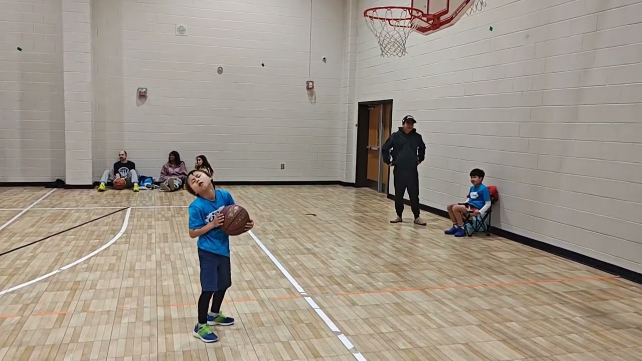 Tiny boy playing basketball 