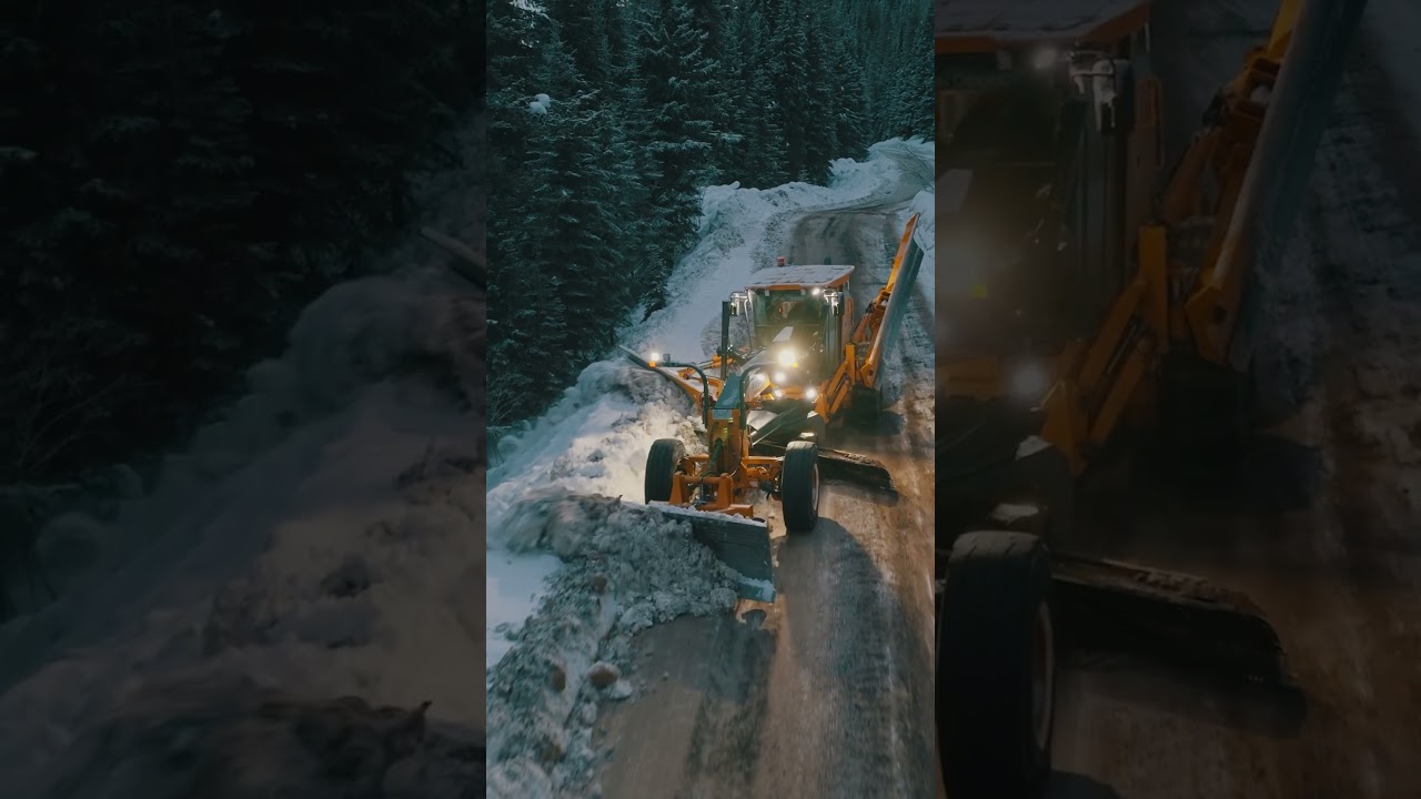 Unique twin wing + front angle blade setup on a grader plowing snow in the mountains of BC