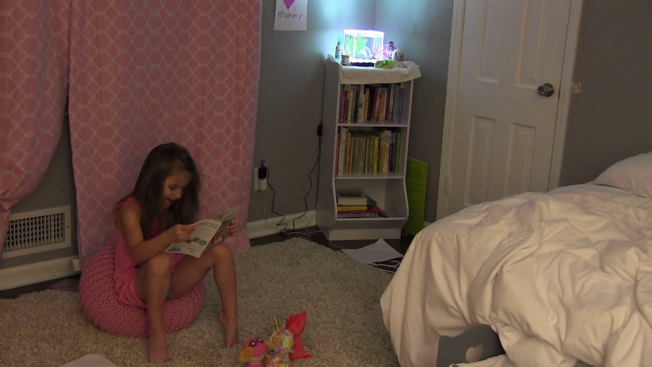 Reading to her stuffed animals