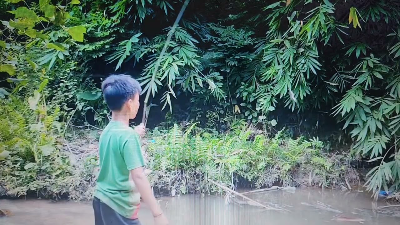 poor village boy catches fish by hand – grills fresh fish by the river