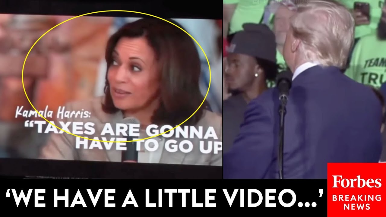 JUST IN: Trump Plays Video On Big Screen For Michigan Rally Crowd To Hammer Kamala Harris On Taxes
