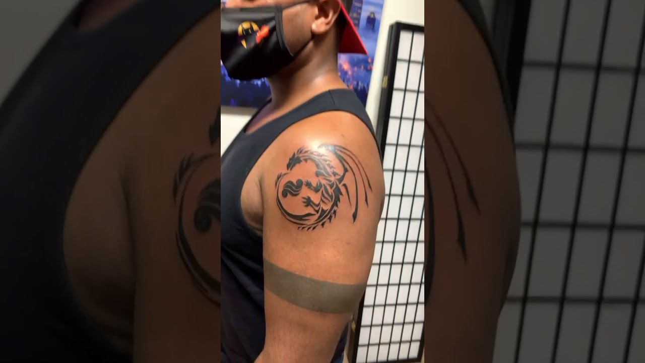 Dragon tattoo tribal arm tattoo by Marvin Rivera - Mariposa Tattoo Studio