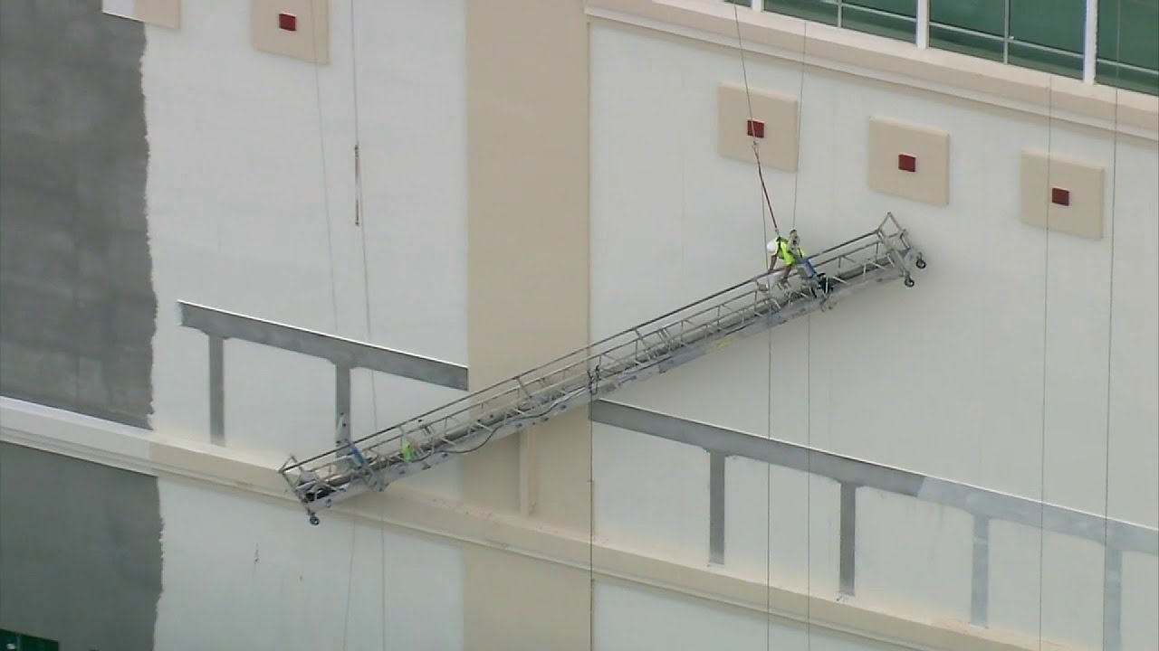 Worker rescued from slanted scaffold