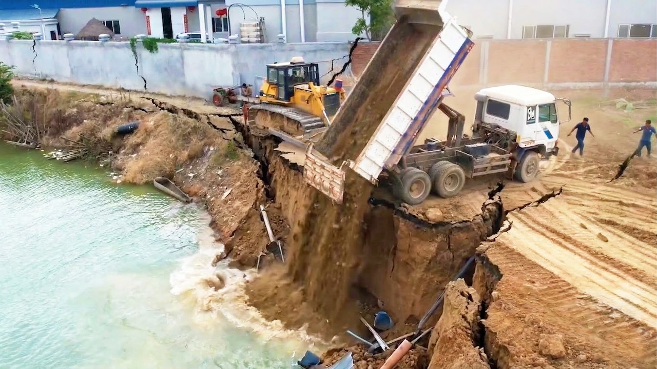 Perfect Activities Increasing Public Road Along The Deep Canal Use 12 Wheel Trucks & Komatsu Dozer