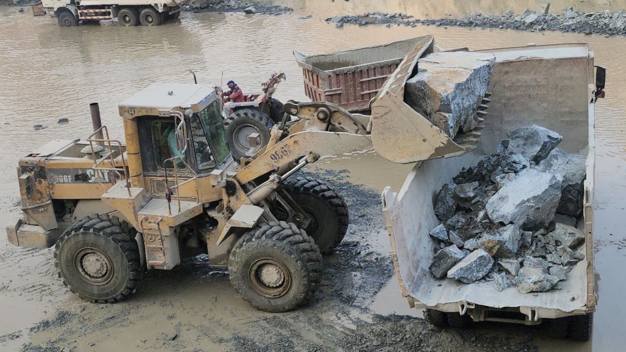 Heavy Duty Mining: 966F Loader Loading Massive Rocks in Deep Water!