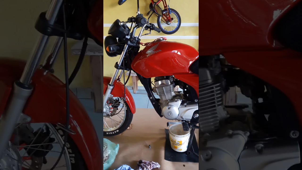Titan 150 vermelha cromada toda no detalhe.