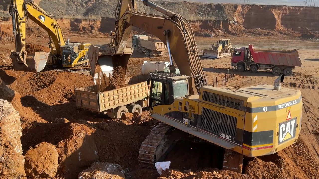 Two Caterpillar 365C Excavators Loading Trucks
