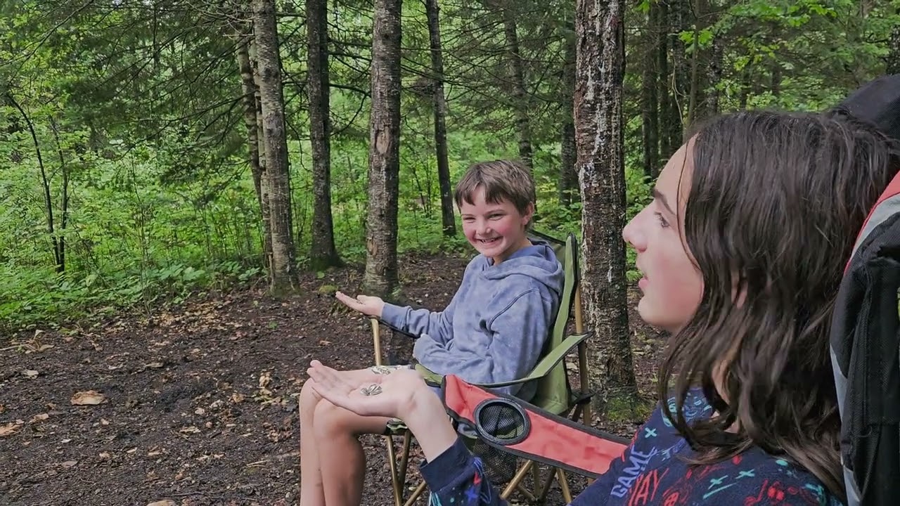 Hand feeding chickadees in the rain