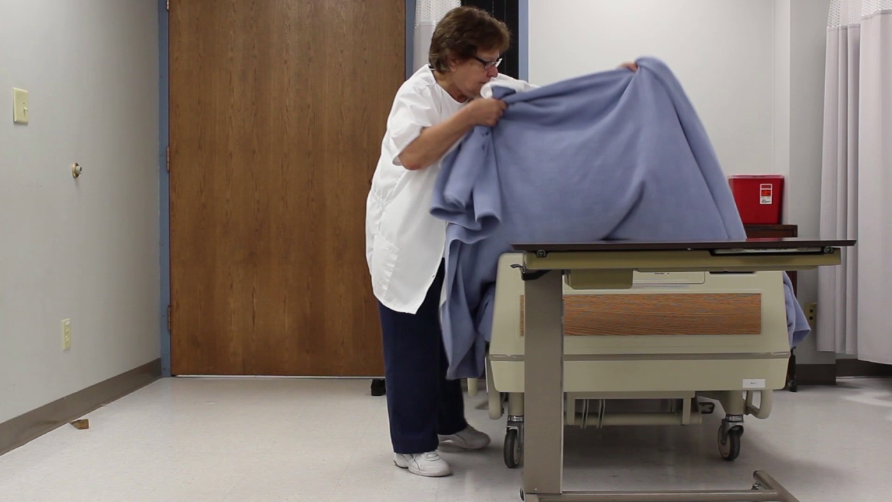 Assisting a resident to sit up on side of bed dangling