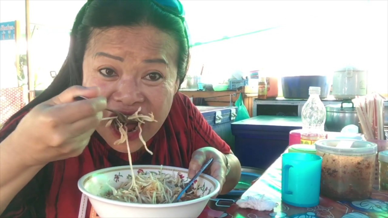 Eating spicy noodles in Soi Buakow in Pattaya. They are delicious and the weather is extremely hot.