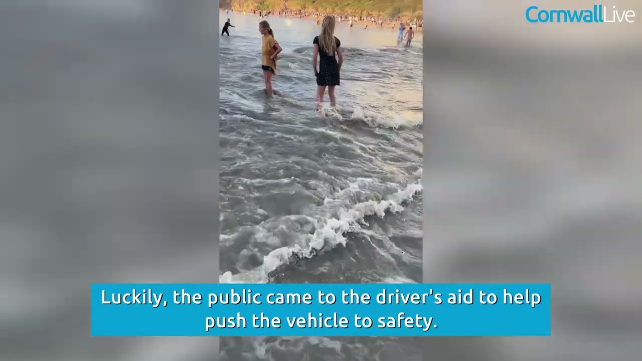 Tourists cars stranded in the sea after parking on the beach in Polzeath