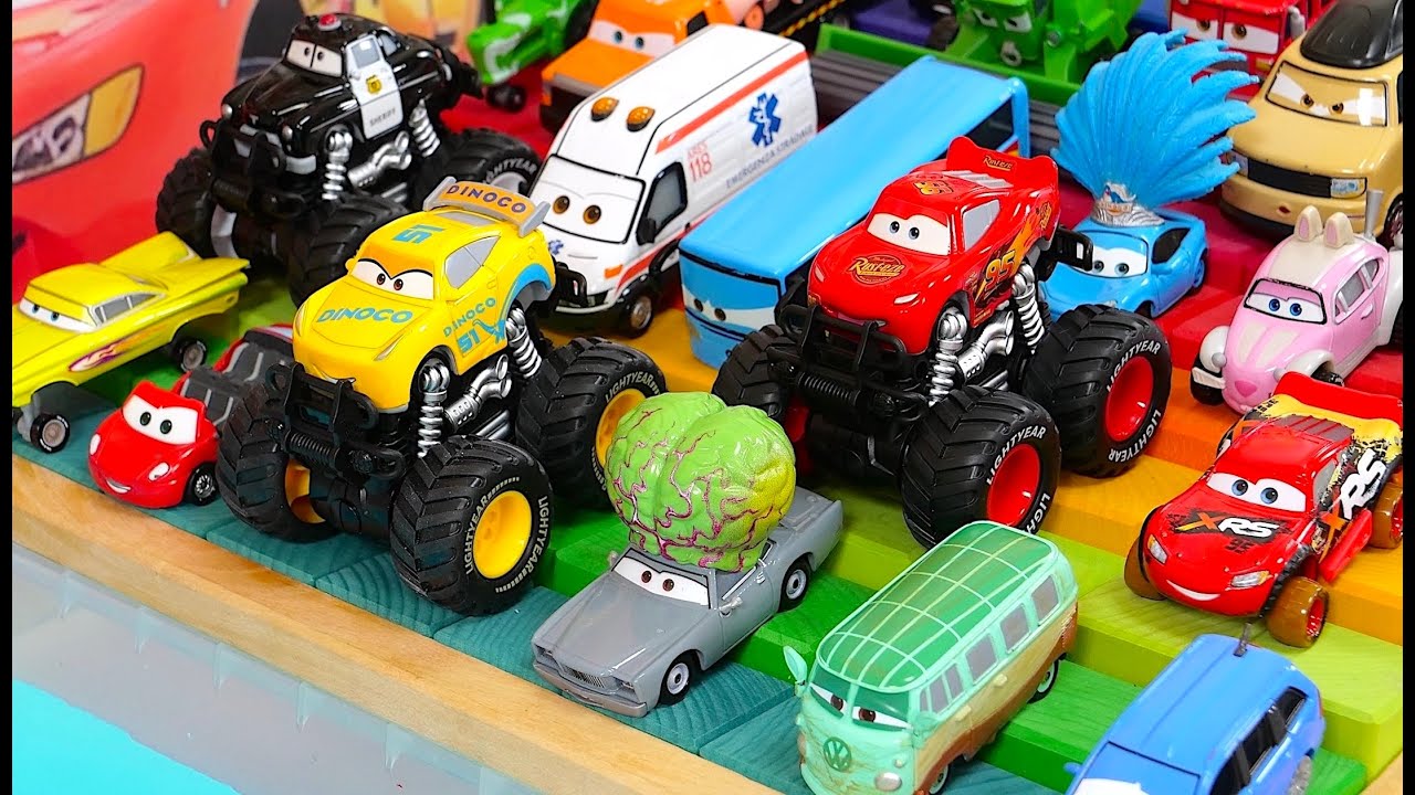 Cars mini cars race down a rainbow-colored slope and sink into blue  jelly water