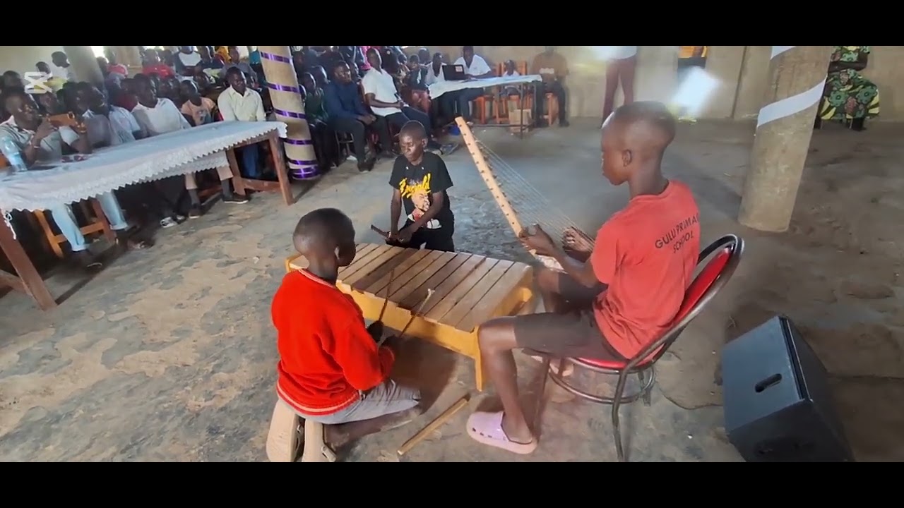 Kids from rural areas in Uganda playing xylophone during music camp at Chrysalis Secondary School
