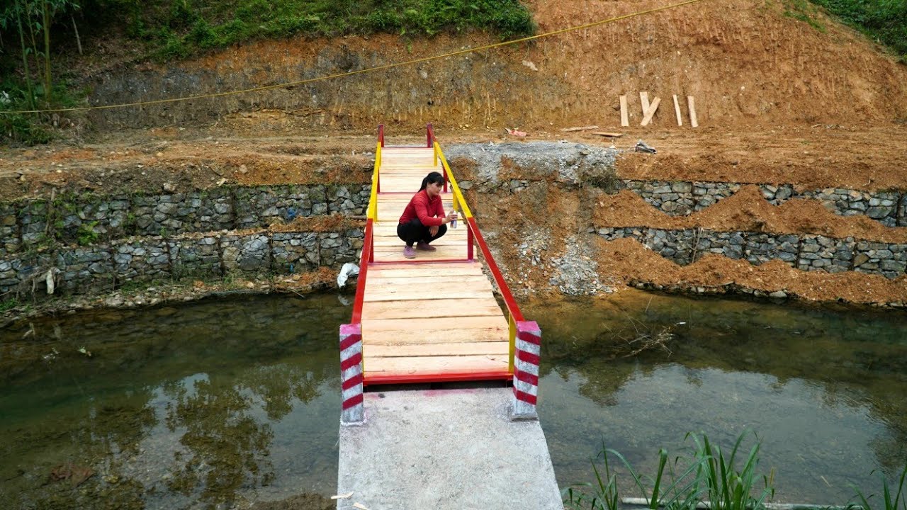 Welding the iron frame - completing the bridge over the stream.