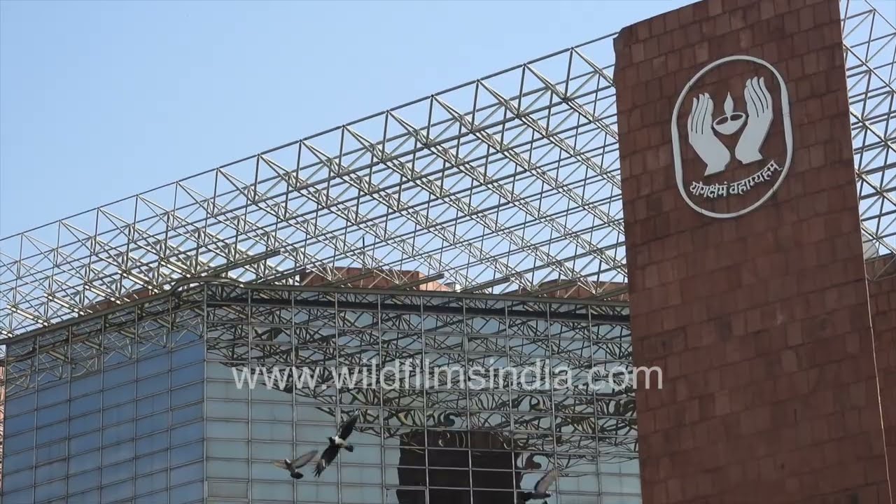 Traffic passing the iconic LIC Building at Connaught Place, New Delhi