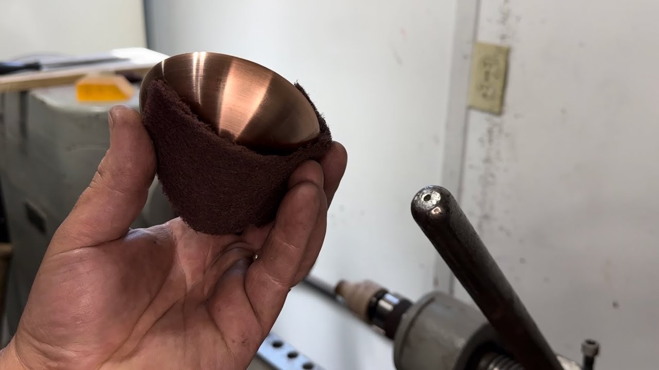 turning a copper bowl on the metal spinning lathe
