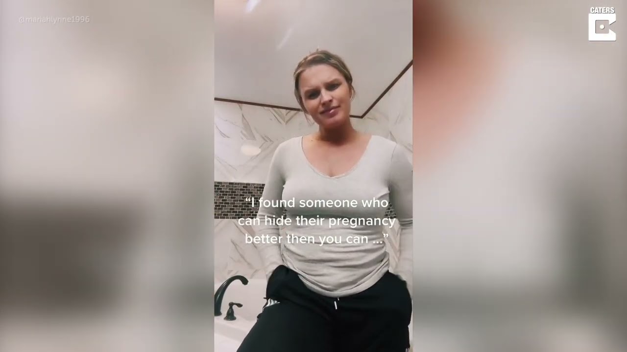 HEAVILY PREGNANT WOMAN HIDES BABY BUMP