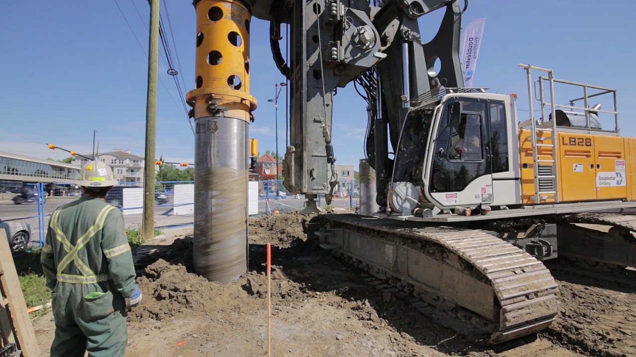 Liebherr LB 24 and LB 28 installing seacant pile wall using segmental casing