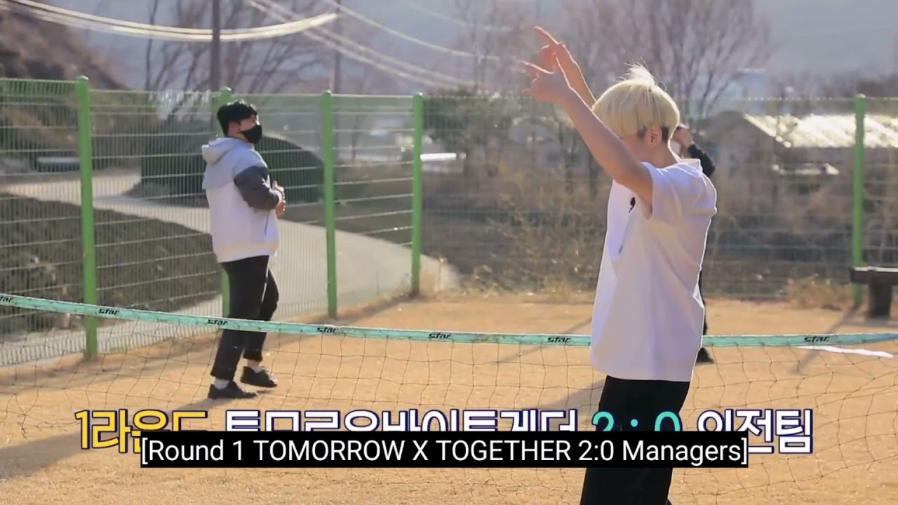 TXT playing foot volleyball with staffs