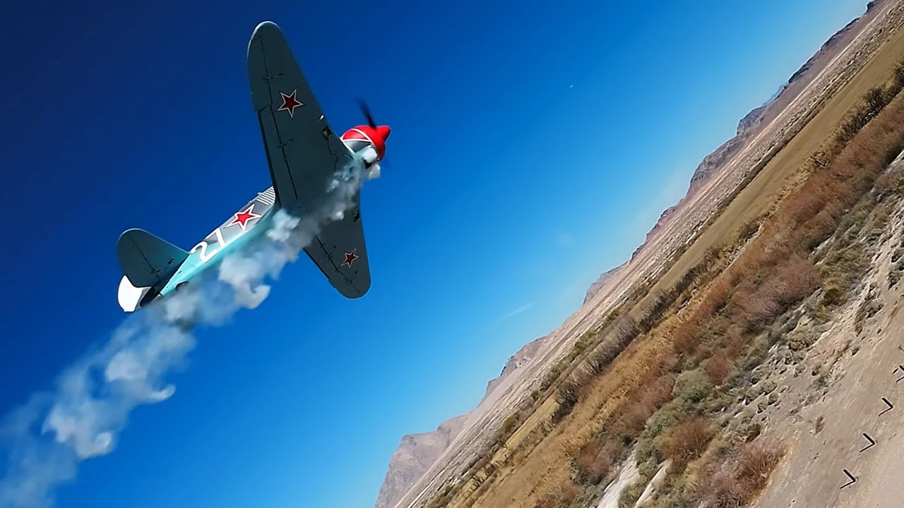 P51 red tail touches shadow LA7 with smoke 