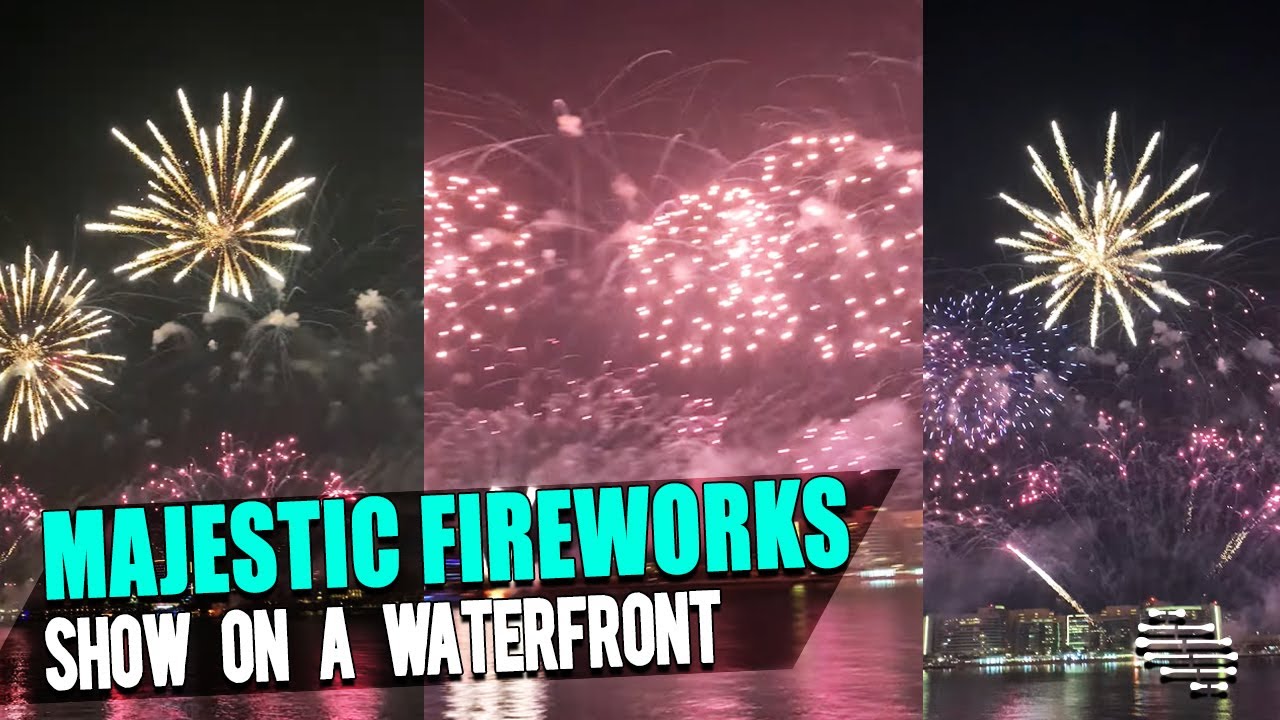 Majestic Fireworks Show on a Waterfront During the Night as People Watch