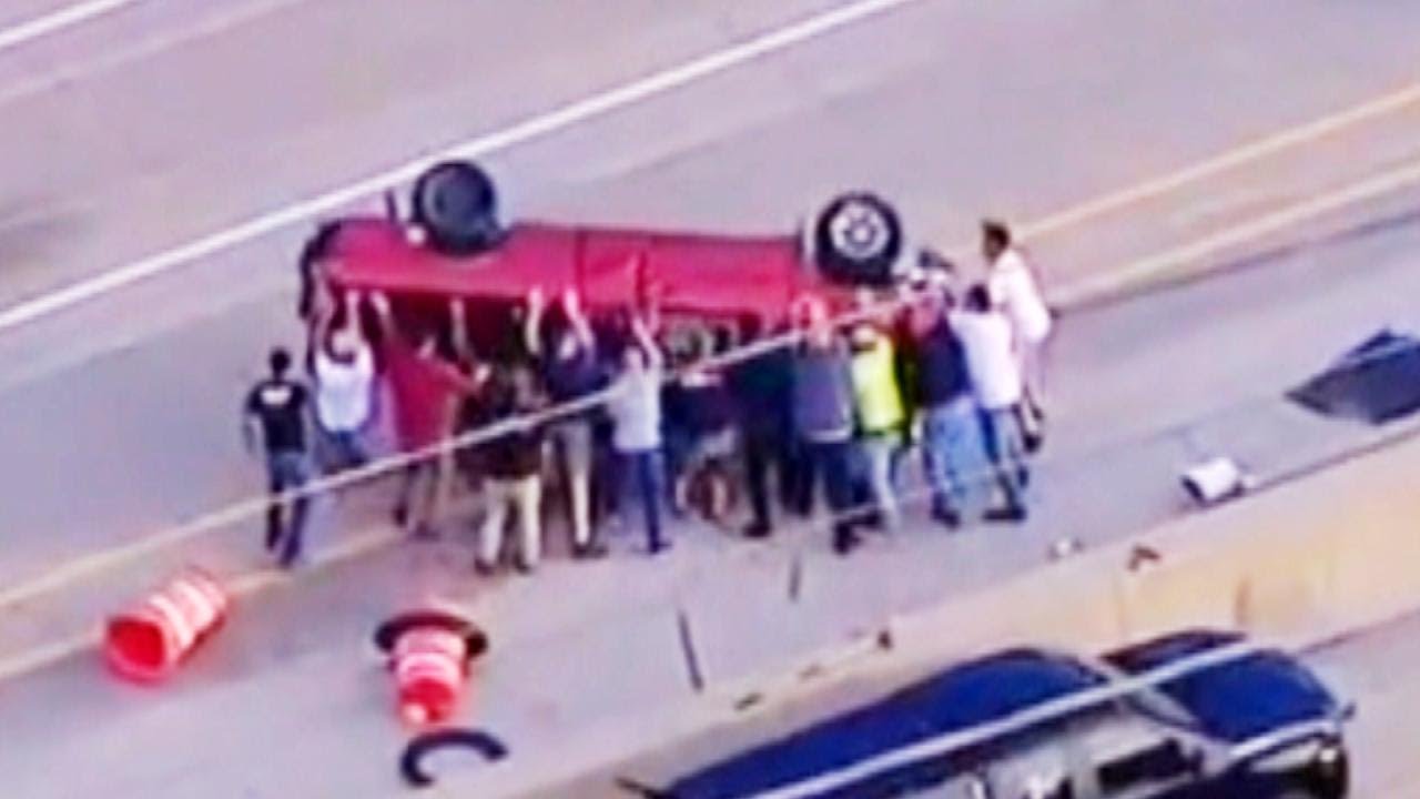 People Help Rescue Driver Trapped in Pickup