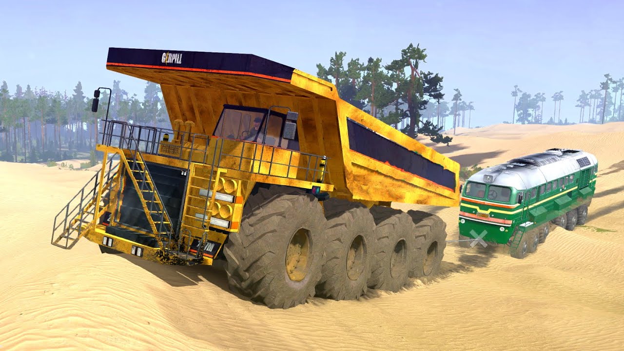Giant Mining Dump Truck Pulls A Train Through The Sand