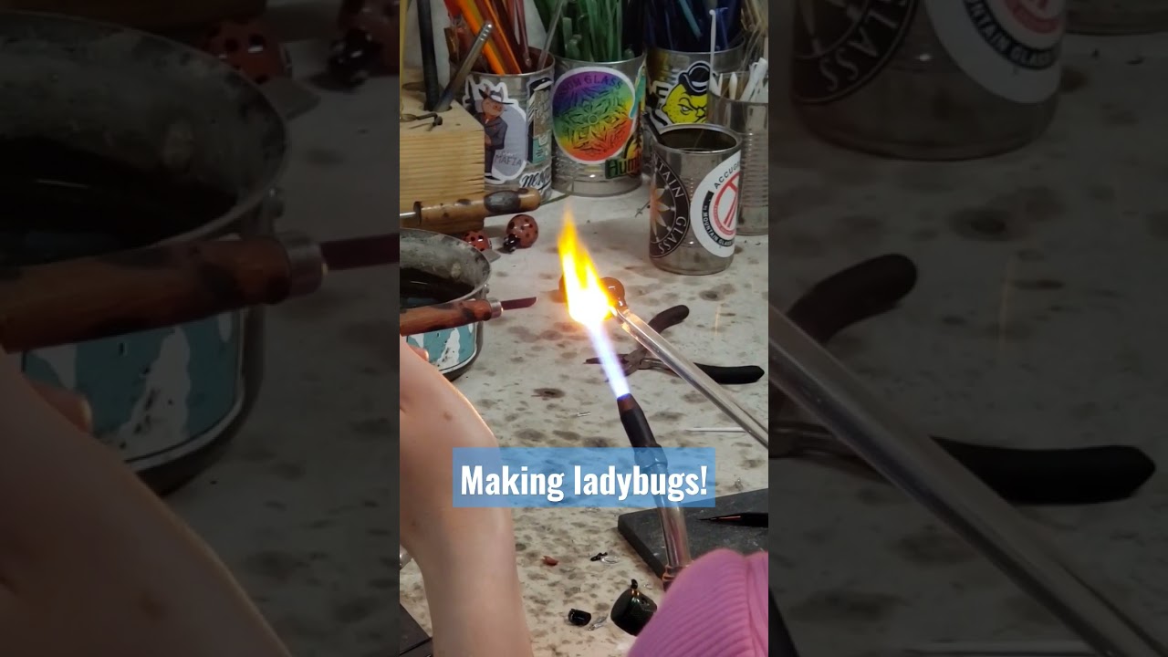 Having fun making ladybugs! Spinning hot glass on the torch! #ladybug #smile #glass #fire #art #fun