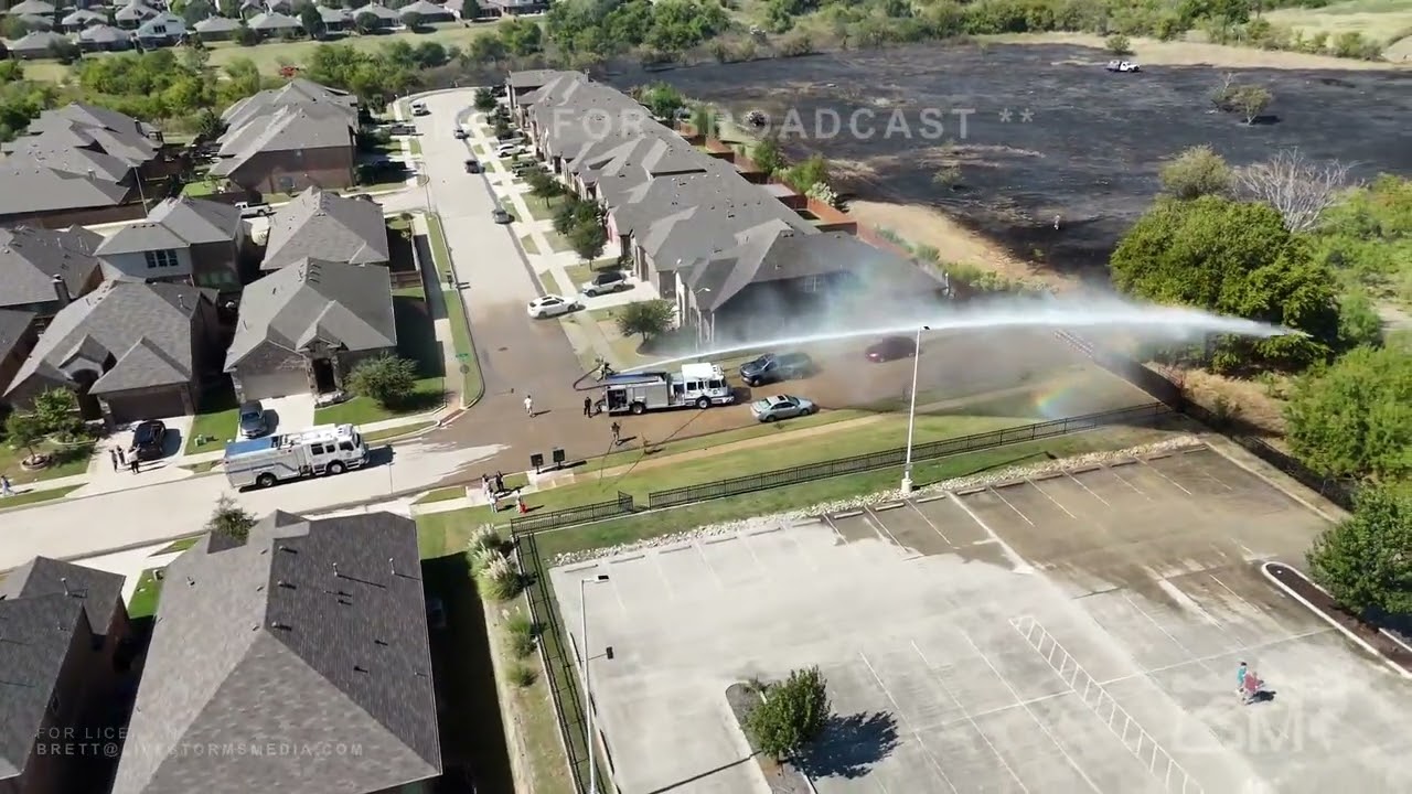10-21-2025 Fort Worth, TX  - Residents use garden hoses to help fight 2 alarm grass fire