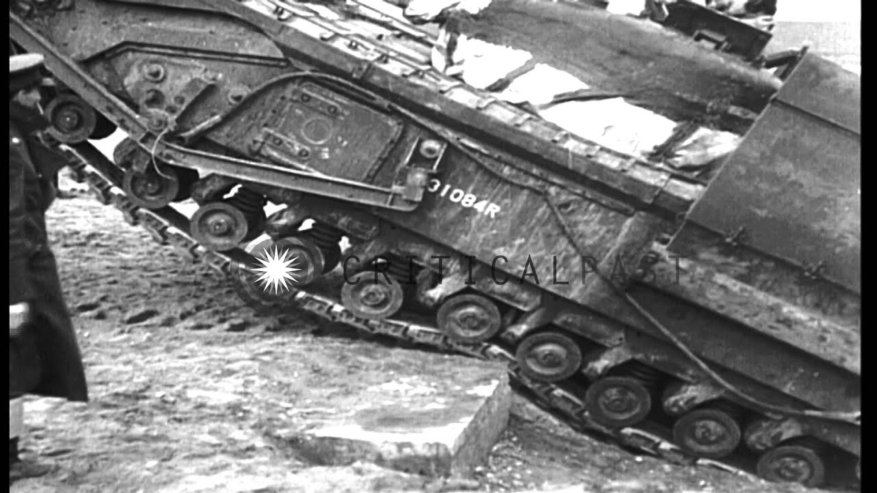 British Army tanks cross obstacles on a beach using Chespaling device in Europe. HD Stock Footage