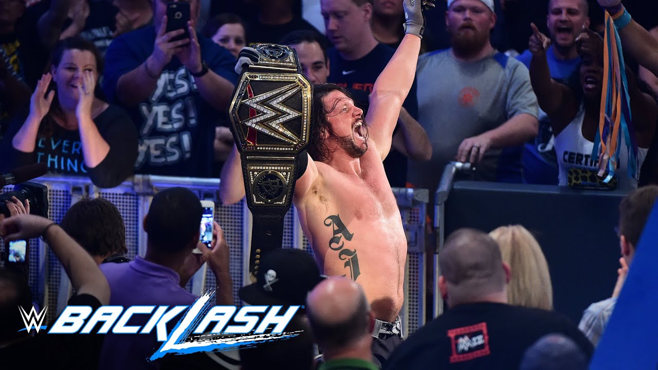 AJ Styles raises his hands high as the new WWE World Champion: Backlash 2016