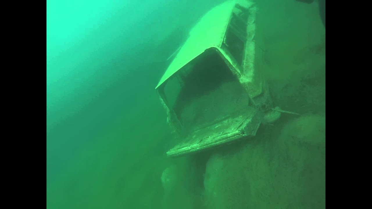 sunken vehicles at rock quarry