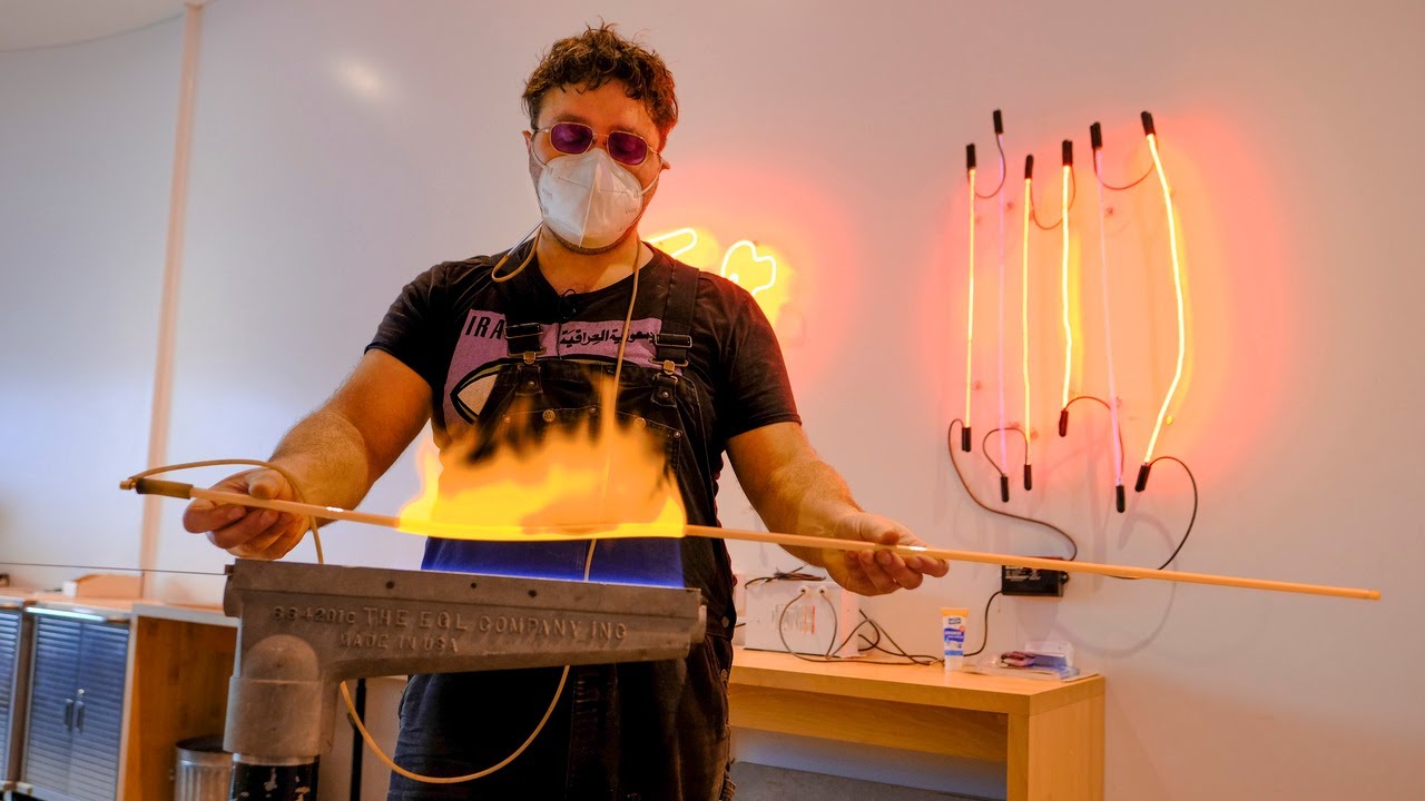 Artist bends a glass tube in new neon sign studio opening at TMA