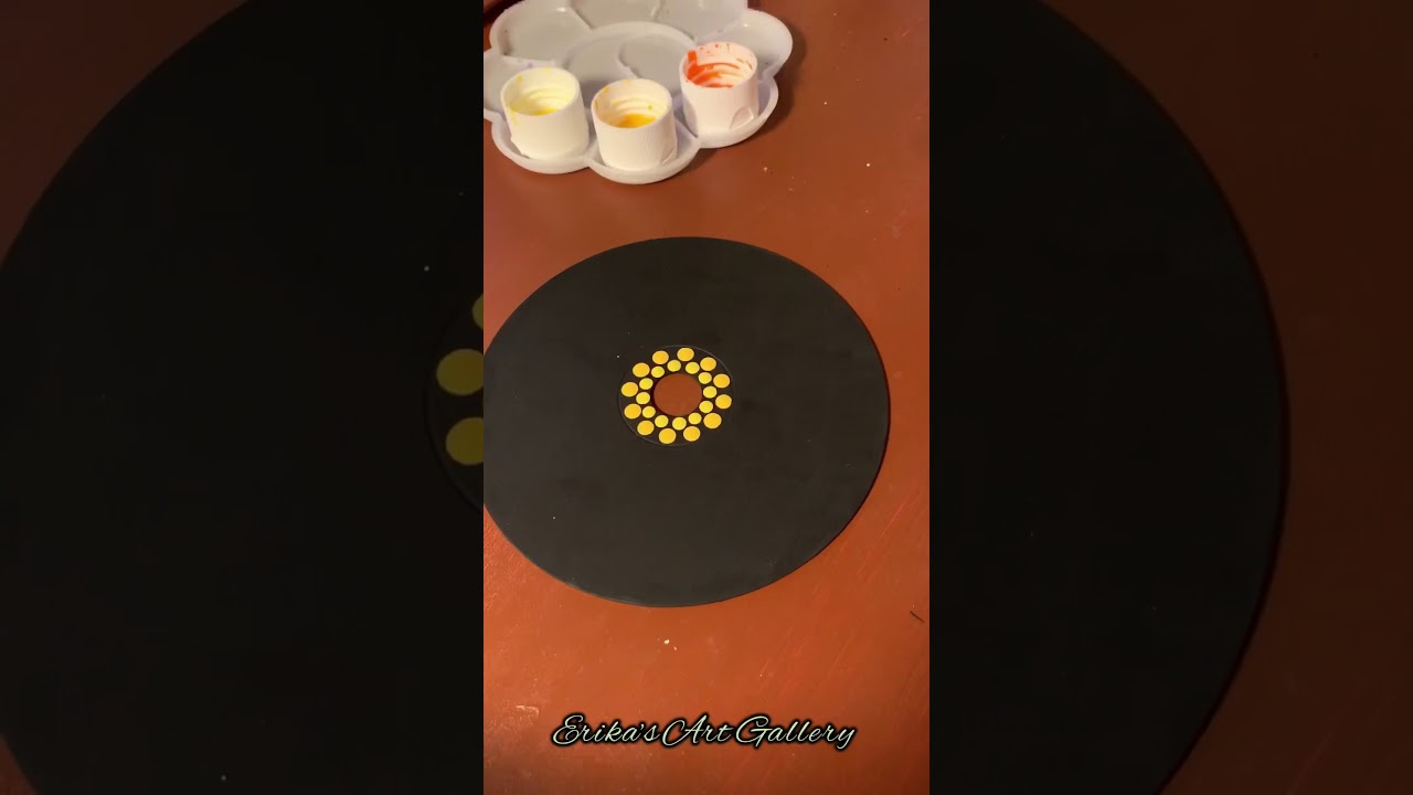 Dot mandala painting on a used CD
