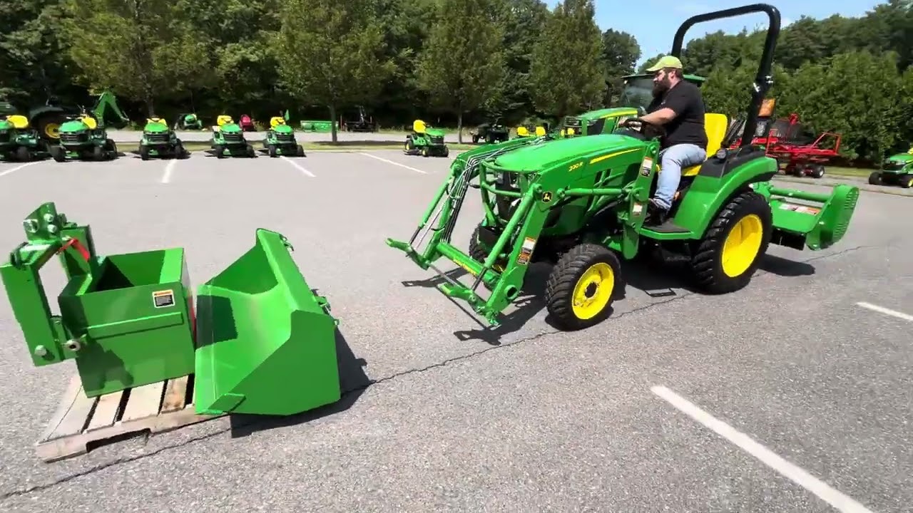 John Deere 2032R compact tractor taking off forks and putting on bucket
